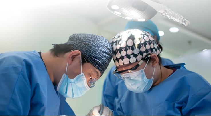 Medical team in scrubs under an operating light, image links to "Opportunities" page.